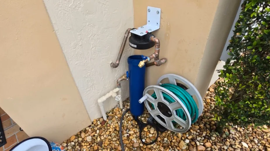 Exterior copper water piping on a Miami stucco wall