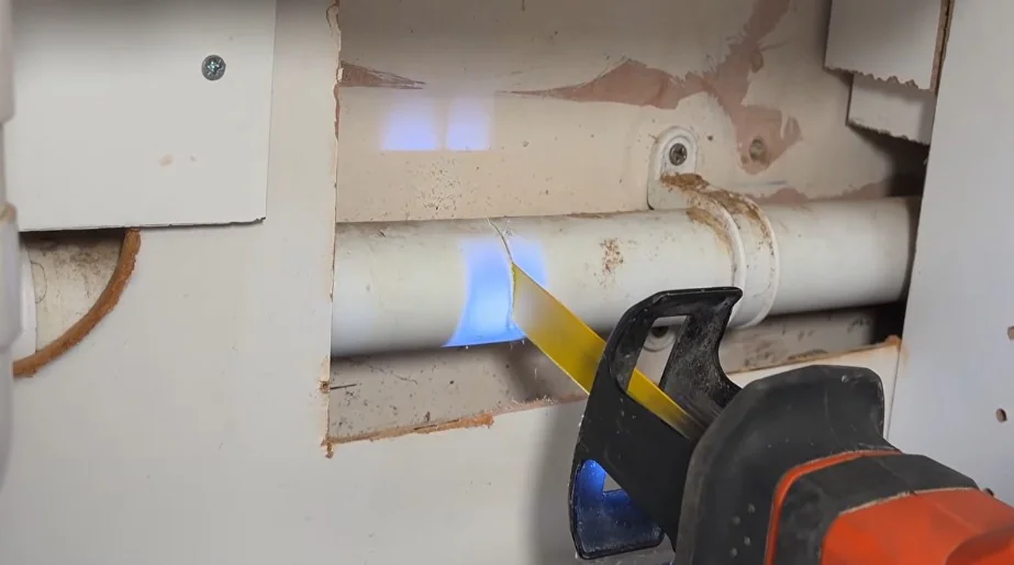Exploratory wall opening to reach a hidden pipe